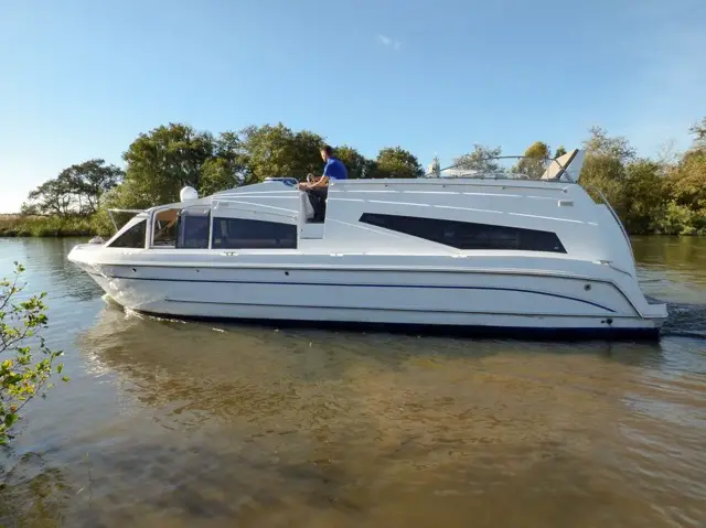 "Image spotlighting exquisite houseboats for hire within the Norfolk Broads, epitomizing the boat hire experience. These opulent floating abodes offer unparalleled comfort and style amidst the scenic beauty of this renowned waterway."