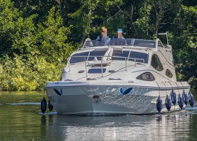 Image illustrating motor yachts available for hire in the Norfolk Broads. The picture showcases sleek and modern vessels, highlighting the luxury and comfort of these boats within this renowned waterway.